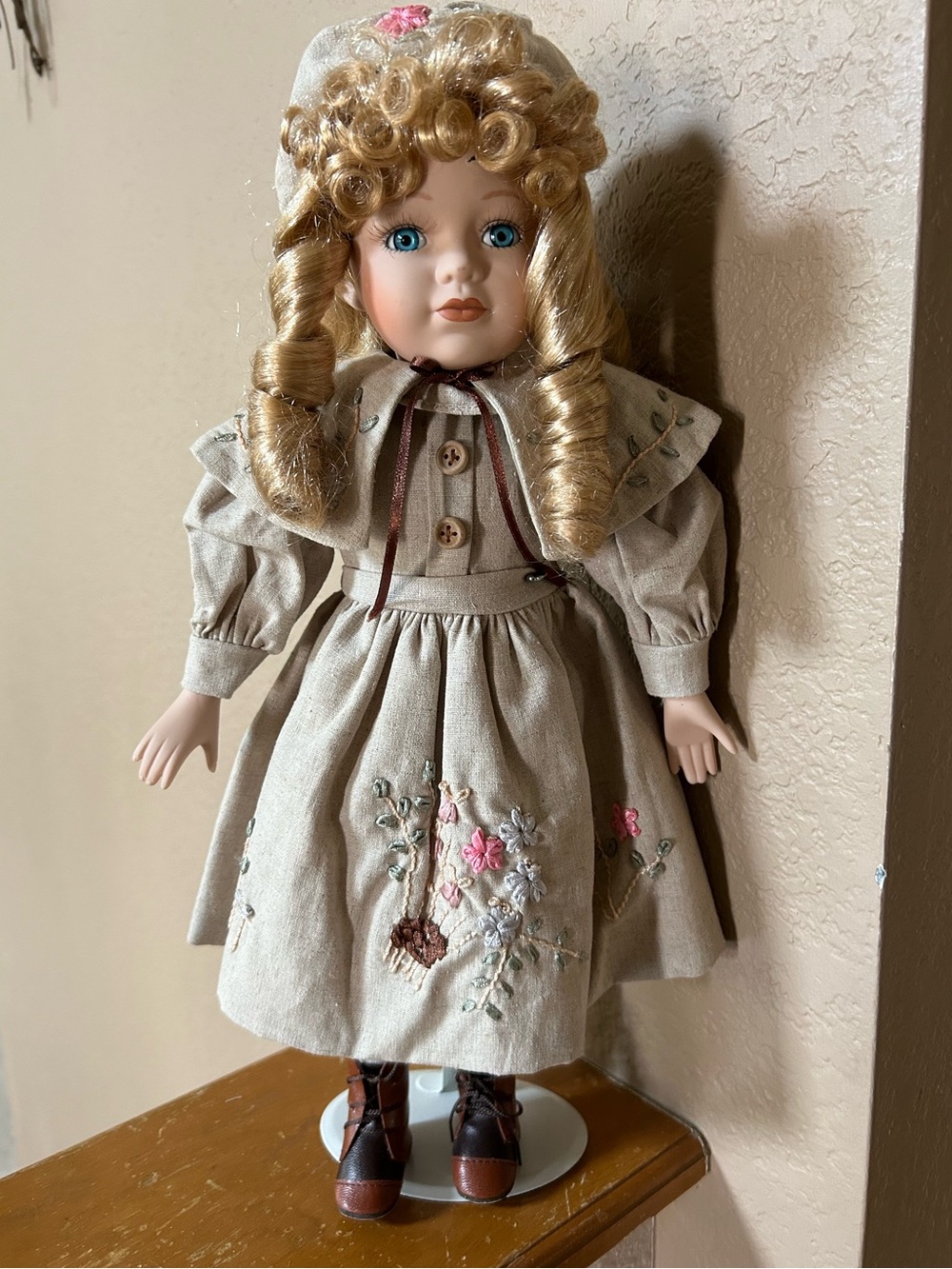 Classic Porcelain Doll in Tan Dress with Embroidered Flowers